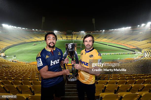 Captain of the Hurricanes Conrad Smith holds the Super 15 trophy with captain of the Highlanders Nasi Manu during the Super Rugby Final media...