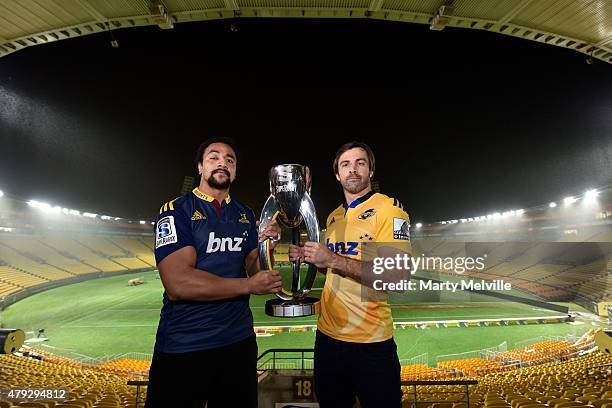 Captain of the Hurricanes Conrad Smith holds the Super 15 trophy with captain of the Highlanders Nasi Manu during the Super Rugby Final media...