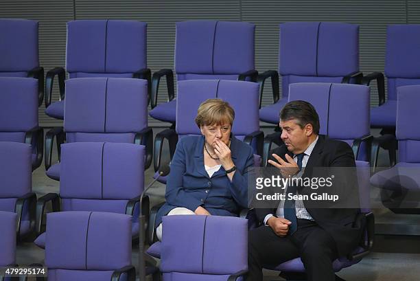 German Chancellor Angela Merkel and Vice Chancellor and Economy and Energy Minister Sigmar Gabriel attend a session of the Bundestag on July 3, 2015...