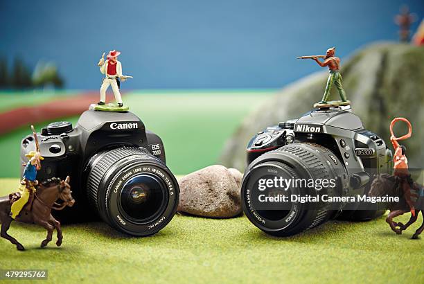 Canon EOS 700D and Nikon D5300 photographed with cowboy and indian toys for a feature on Nikon and Canon brands, taken on June 11, 2014.