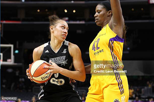 Dearica Hamby of the San Antonio Stars handles the ball against Jantel Lavender of the Los Angeles Sparks in a WNBA game at Staples Center on July 2,...
