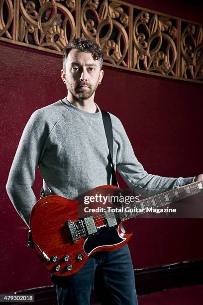 Portrait of American musician Tim McIlrath, guitarist and vocalist with punk rock group Rise Against, photographed before a live performance at the...