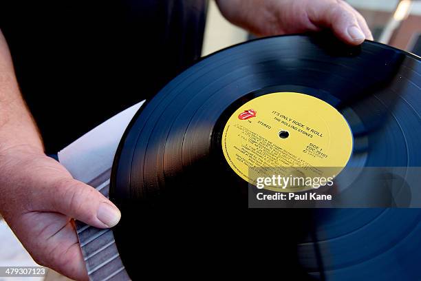 Rolling Stones fan holds a vinyl LP outside the Hyatt Regency Perth hotel where Mick Jagger and the Rolling Stones are staying during the first leg...