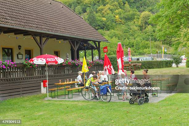 people are enjoying outdoor cafe at willendorf austria - venus of willendorf statue stock pictures, royalty-free photos & images