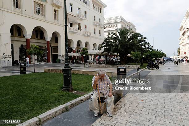 An elderly man sits and rests with his walking stick on Aristotelous square in Thessaloniki, Greece, on Friday, July 3, 2015. Greece is divided right...