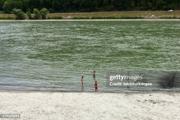 children are playing by danube river at austria - venus of willendorf statue stock pictures, royalty-free photos & images