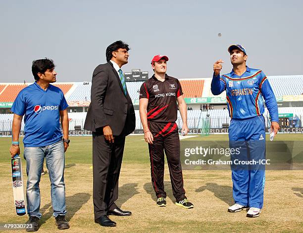 Mohammad Nabi , captain of Afghanistan and Jamie Atkinson, captain of Hong Kong at the coin toss with match referee Javagal Srinath and pepsi mascot...