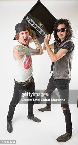 Portrait of guitarists Ben Bruce and Cameron Liddell of English metalcore group Asking Alexandria photographed with a Peavey amp backstage at...