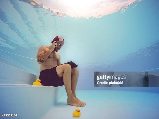workaholic man underwater - sport tablet stock pictures, royalty-free photos & images
