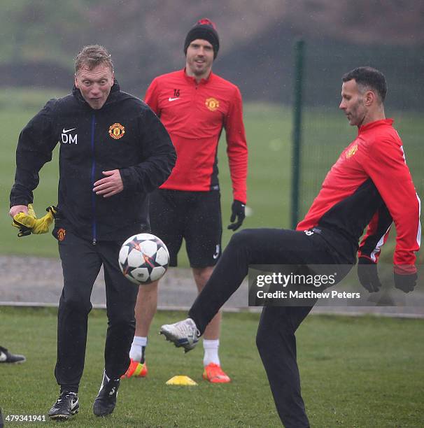 Manager David Moyes and Ryan Giggs of Manchester United in action during a first team training session, ahead of their UEFA Champions League Round of...