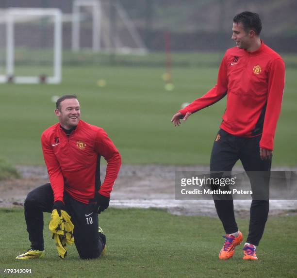Wayne Rooney and Robin van Persie of Manchester United in action during a first team training session, ahead of their UEFA Champions League Round of...
