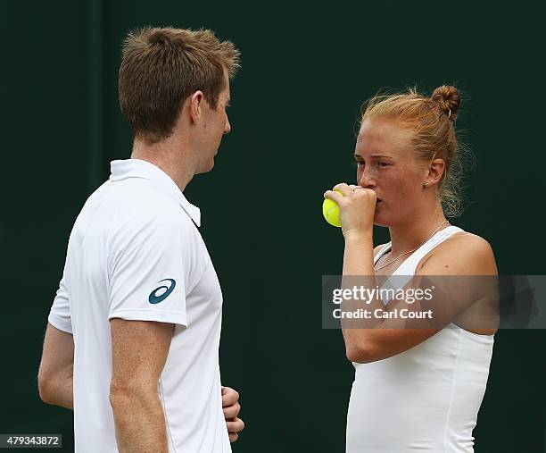 Jonathan Marray of Great Britain and Anna Smith of Great Britain talk tactics in their Mixed Doubles First Round match against Artem Sitak of New...