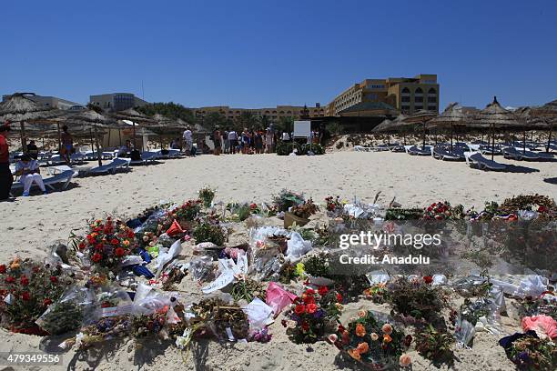 Flowers seen during a remembrance ceremony for the victims of a terror attack on a beach outside the Imperial Marhaba Hotel, in the popular tourist...