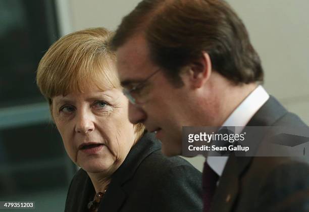 German Chancellor Angela Merkel and Portuguese Prime Minister Pedro Passos Coelho depart after speaking to the media following bilateral talks at the...