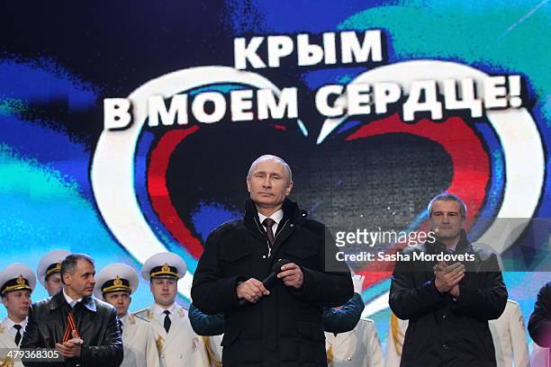 Russian President Vladimir Putin and Crimean Prime Minister Sergei Aksyonov attend a rally at Red Square on March 18, 2014 in Moscow, Russia....