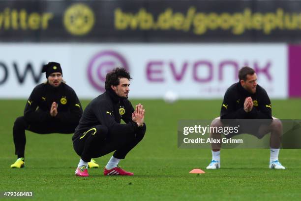 Marcel Schmelzer, Mats Hummels and Julian Schieber exercise during a Borussia Dortmund training session ahead of their UEFA Chamions League Round of...