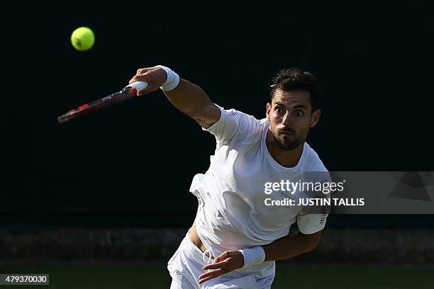 Colombia's Santiago Giraldo serves against US player Denis Kudla during their men's singles third round match on day five of the 2015 Wimbledon...