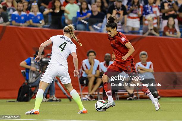 Celia Sasic of Germany tries to move the ball past Becky Sauerbrunn of USA during the 2015 FIFA Women's World Cup semi final match at Olympic Stadium...