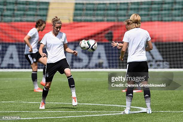 Germany players Simone Laudehr and Saskia Bartusiak practice during a training session at Commonwealth Stadium on July 3, 2015 in Edmonton, Canada.