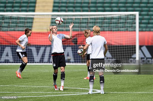 Germany players Simone Laudehr and Saskia Bartusiak practice during a training session at Commonwealth Stadium on July 3, 2015 in Edmonton, Canada.