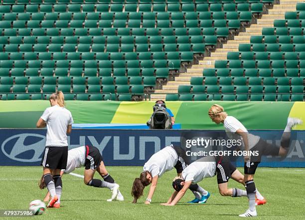 German players warm up during the team's training session at the 2015 FIFA Women's World Cup in Edmonton on July 3, 2015. Germany meets England on...