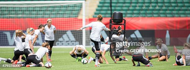 German players are watched by a remote camera as they warm up during the team's training session at the 2015 FIFA Women's World Cup in Edmonton on...