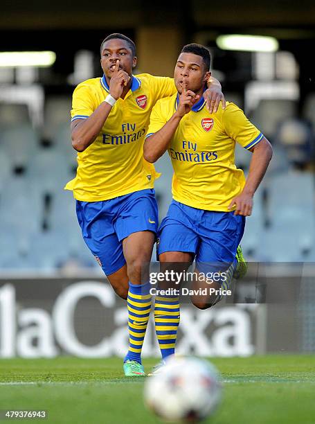 Serge Gnabry of Arsenal celebrates scoring a goal with team-mate Chuba Akpom during the UEFA Youth League Quarter Final match between Barcelona U19...