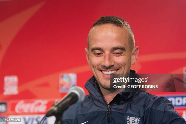 England's head coach Mark Sampson smiles as he arrives for a press conference at the FIFA Women's World Cup in Edmonton on July 3, 2015. England...