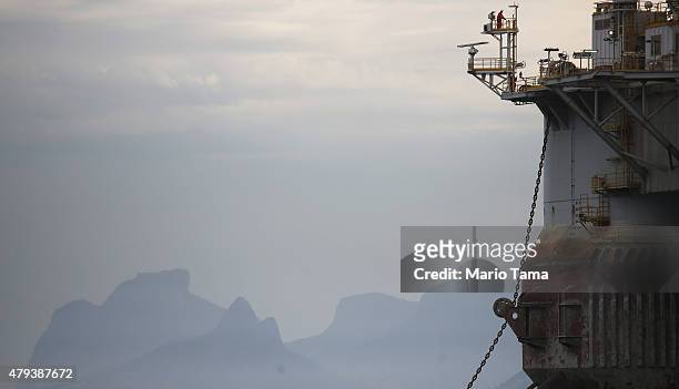 Worker is perched on a Petrobras oil platform floating in the Atlantic Ocean near Guanabara Bay on July 3, 2015 in Rio de Janeiro, Brazil. The...