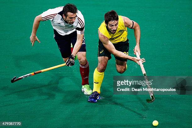 Kiel Brown of Australia battles for the ball with David Condon of Great Britain during the Fintro Hockey World League Semi-Final match between...