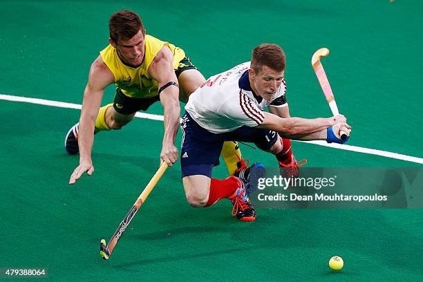 Tristan White of Australia attempts to stop Sam Ward of Great Britain shooting on goal during the Fintro Hockey World League Semi-Final match between...