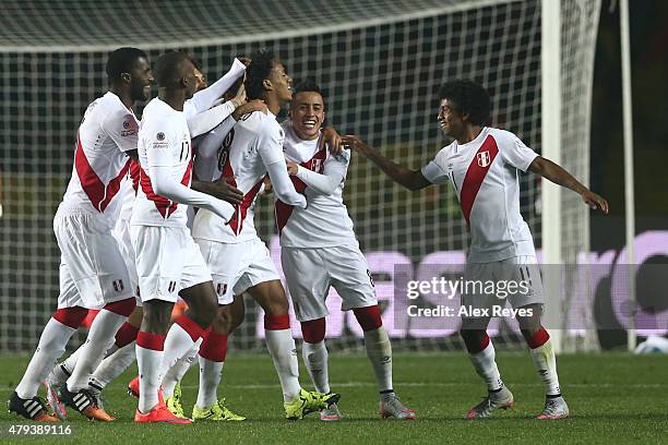 Andre Carrillo of Peru celebrates with teammates after scoring the opening goal during the 2015 Copa America Chile Third Place Playoff match between...