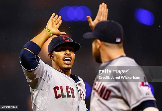 Francisco Lindor of the Cleveland Indians celebrates with teammate Jason Kipnis after turning the inning-ending double play in the sixth inning...
