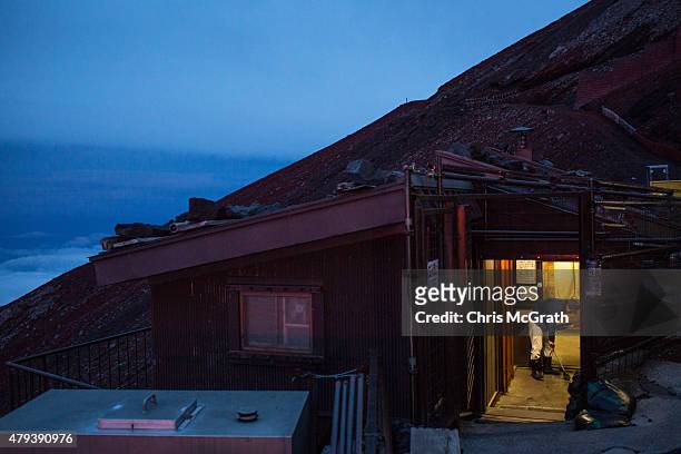 Man cleans a restroom at a mountain hut on the way to the summit of Mt. Fuji on July 2, 2015 in Fujiyoshida, Japan. Mt Fuji is Japan's highest peak...