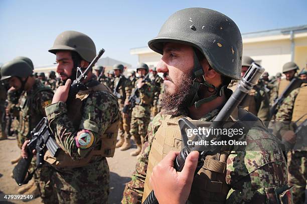Soldiers with the Afghan National Army graduate from basic training during a ceremony at the ANA's Combined Fielding Center on March 18, 2014 in...
