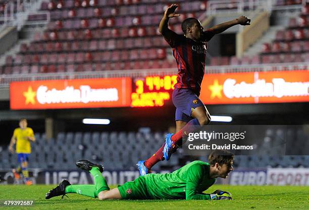 Adama Traore of FC Barcelona celebrates past Josh Vickers of Arsenal after scoring his team's fourth goal during the UEFA Youth League Quarter FInal...