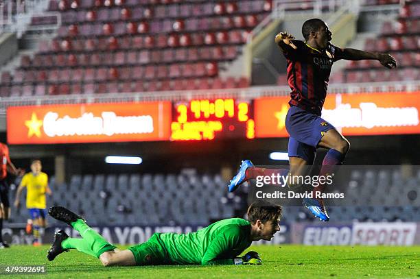Adama Traore of FC Barcelona celebrates past Josh Vickers of Arsenal after scoring his team's fourth goal during the UEFA Youth League Quarter FInal...