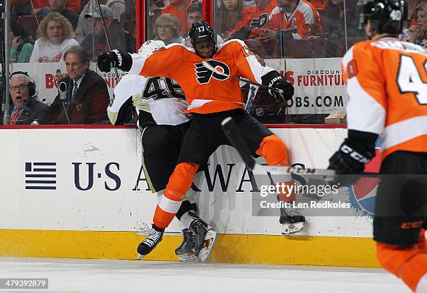 Wayne Simmonds of the Philadelphia Flyers checks Joe Vitale of the Pittsburgh Penguins along the boards on March 15, 2014 at the Wells Fargo Center...