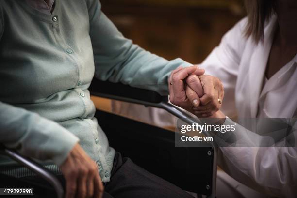 nurse during home visit with senior woman - doctors embracing stock pictures, royalty-free photos & images