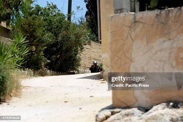 An Israeli soldier points an M-16 rifle at journalists and protesters in the West Bank Palestinian village of Kafr Qaddum. In the Palestinian West...