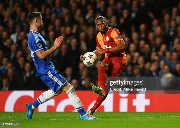 Didier Drogba of Galatasaray shoots past Gary Cahill of Chelsea during the UEFA Champions League Round of 16 second leg match between Chelsea and...