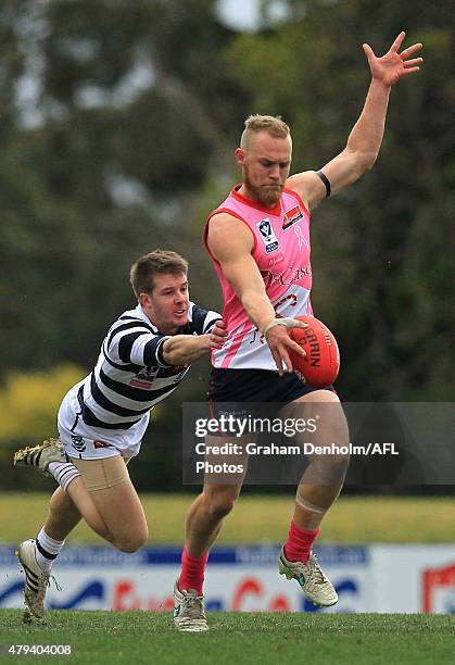 Dean Terlich of the Scorpions gets a kick away under pressure during the round 12 VFL match between the Casey Scorpions and the Geelong Cats at Casey...