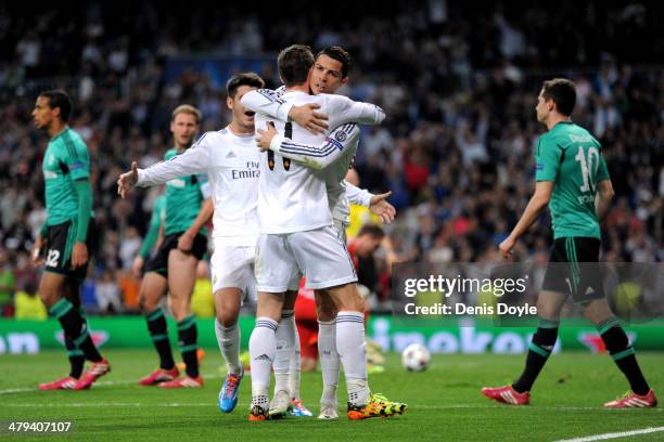 Cristiano Ronaldo of Real Madrid celebrates with teammate Gareth Bale after scoring the opening goal during the UEFA Champions League Round of 16,...