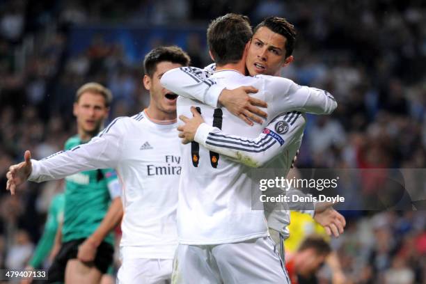 Cristiano Ronaldo of Real Madrid celebrates with teammate Gareth Bale after scoring the opening goal during the UEFA Champions League Round of 16,...