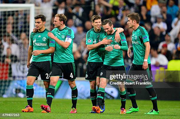 Tim Hoogland of Schalke is congratulated by teammates after scoring a goal to level the scores at 1-1 during the UEFA Champions League Round of 16,...