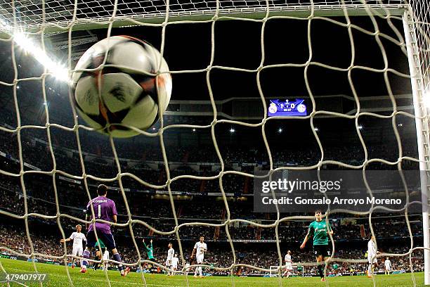 Tim Hoogland of Schalke turns away to celebrate after scoring a goal to level the scores at 1-1 past goalkeeper Iker Casillas of Real Madrid during...