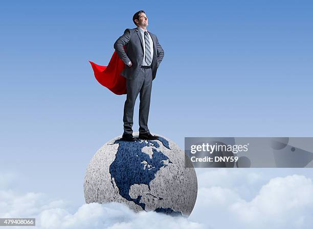 superhero businessman standing on globe - globe businessman stockfoto's en -beelden