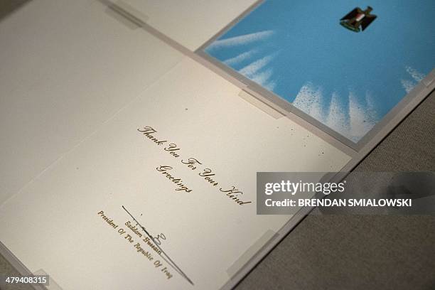 Greeting card from former Iraqi president Saddam Hussein to former US President George H. W. Bush is seen during a press preview at the National...
