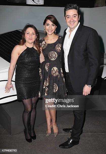 Actress Caterina Murino poses with Jonathan Sands as they attend a party ahead of the opening of the Bond In Motion exhibition at the London Film...