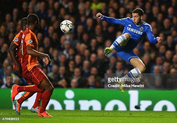 Eden Hazard of Chelsea jumps for the ball as Emmanuel Eboue and Aurelien Chedjou of Galatasaray look on during the UEFA Champions League Round of 16...